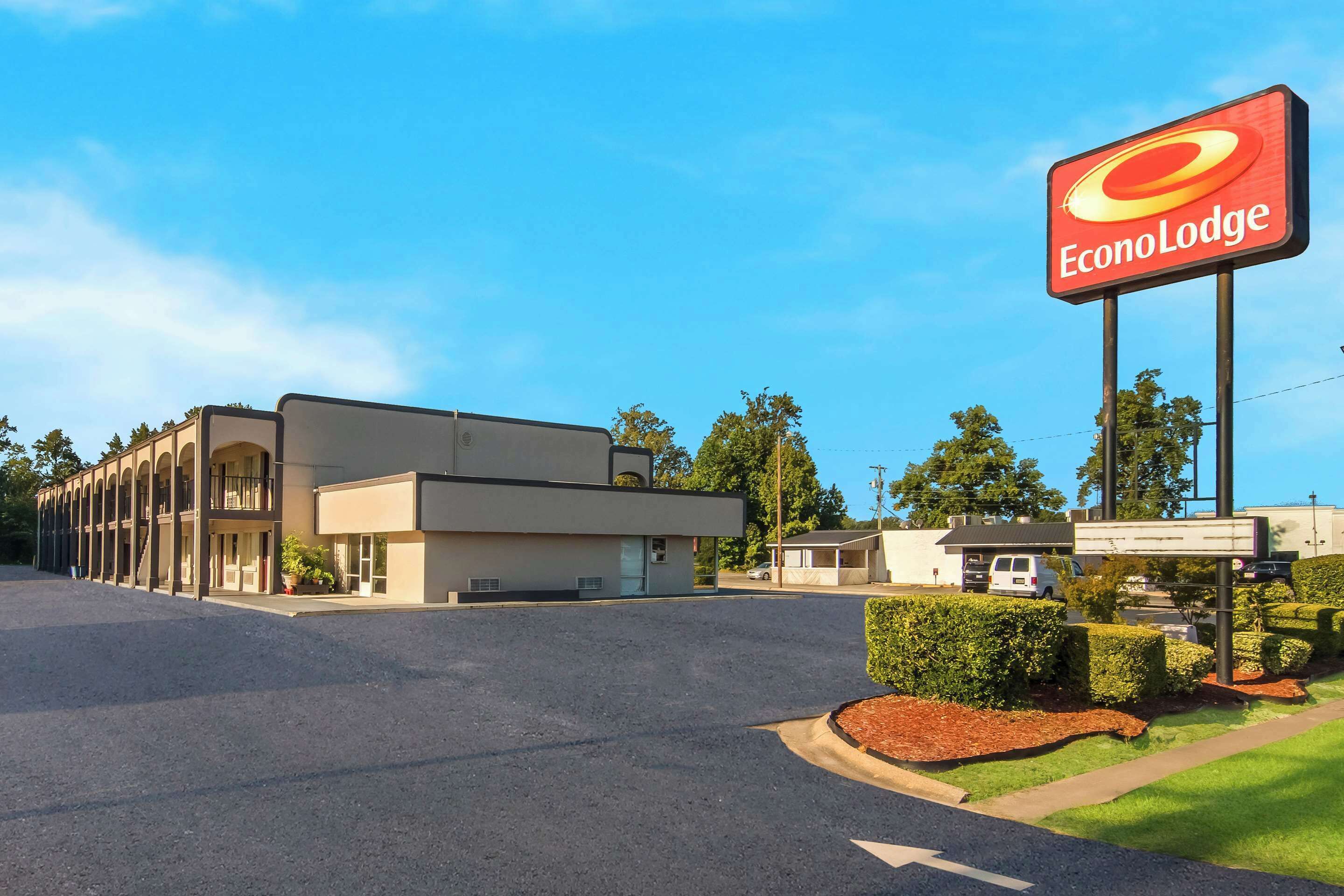 A two-story EconoLodge building with a parking lot in front.