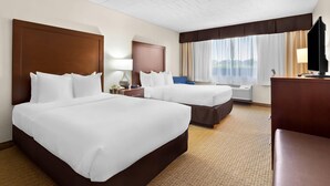 A hotel room with two beds, a desk, a chair, a TV, and a window with curtains. - Comfort Inn Somerset (Somerset)