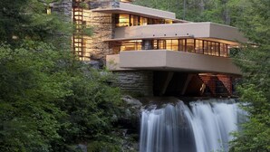 A modern house built over a waterfall surrounded by dense forest. - Comfort Inn Somerset (Somerset)