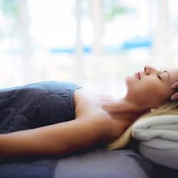 Guests can enjoy a restful stay with a comfortable bed and relaxing massage services.