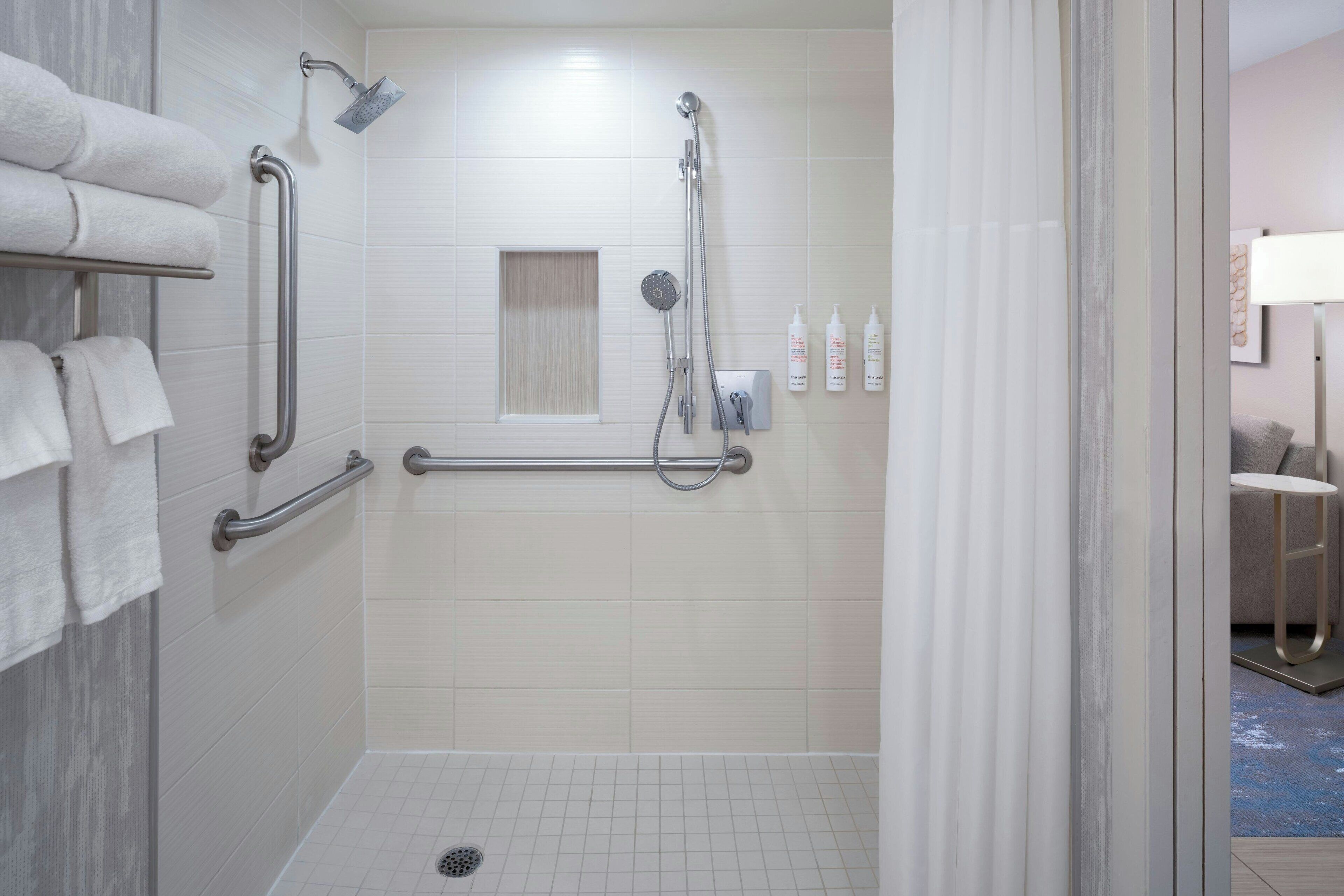 shower, designer toiletries, hair dryer, towels