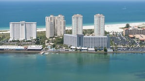 A coastal hotel with multiple high-rise buildings, a beach, and a marina.