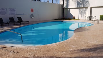 Outdoor pool, open 9:00 AM to 9:00 PM, pool umbrellas
