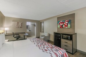 A hotel room with a bed, a desk, a chair, a television, and a microwave. - Red Roof Inn Baltimore (Baltimore)
