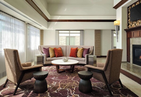 A spacious living room with a sofa set, two armchairs, a coffee table, and a fireplace. - Homewood Suites by Hilton Shreveport / Bossier City, LA (Bossier City)