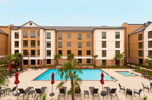 A hotel with a pool area, multiple balconies, and outdoor seating. - Homewood Suites by Hilton Shreveport / Bossier City, LA (Bossier City)