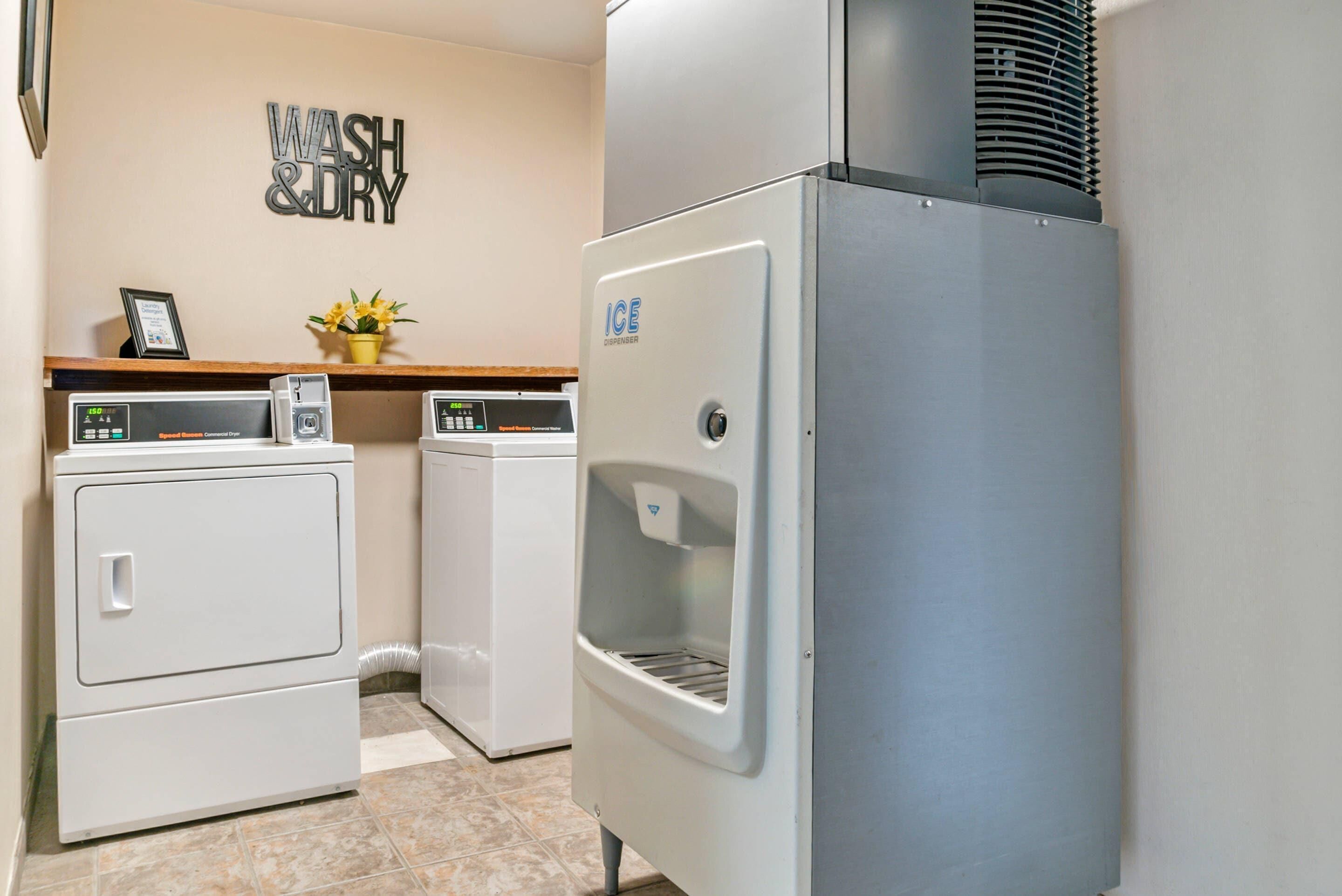 A laundry area with a washing machine, dryer, and an ice dispenser.