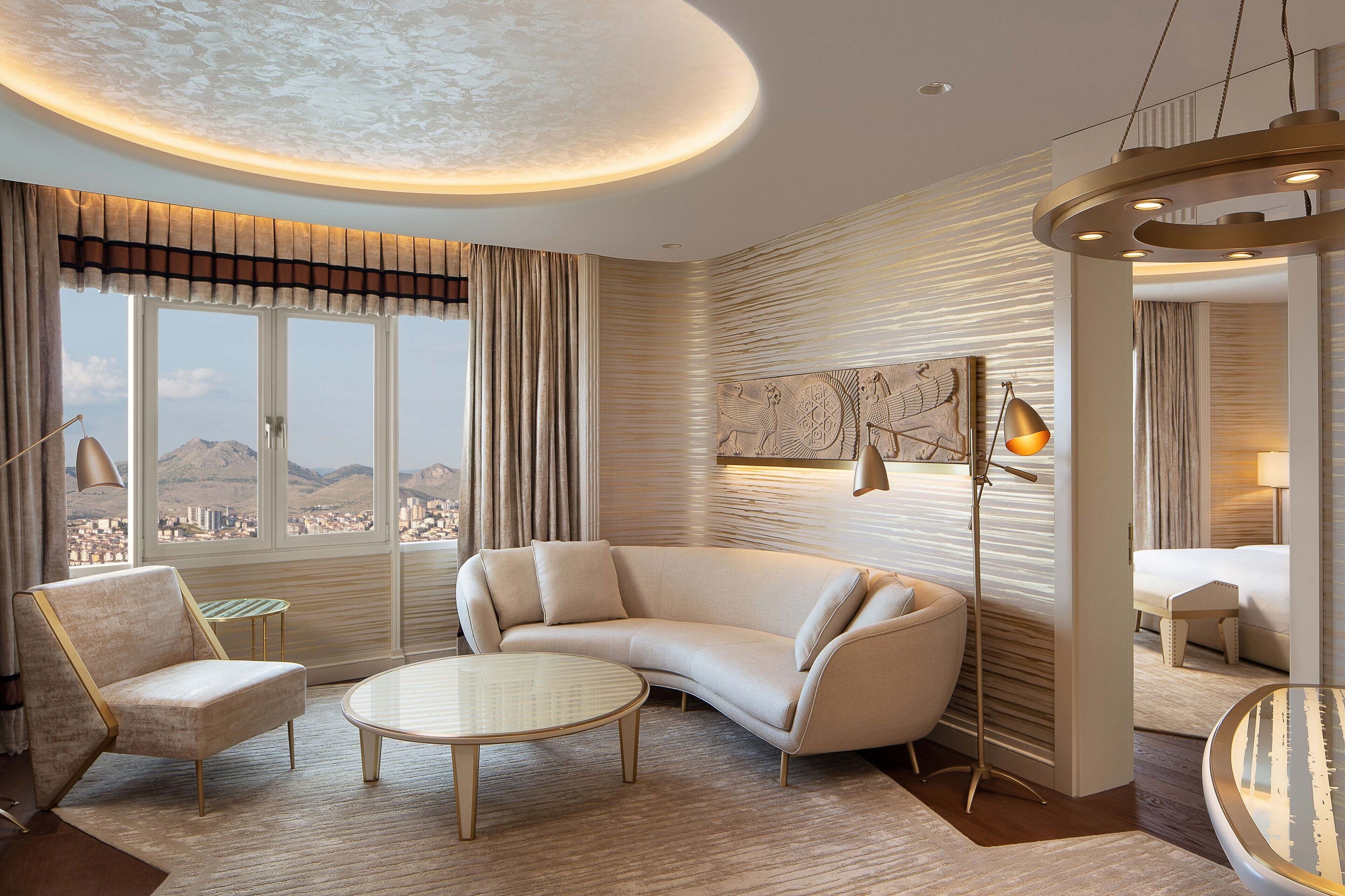 A modern living room with a curved sofa, a round coffee table, and a floor lamp.