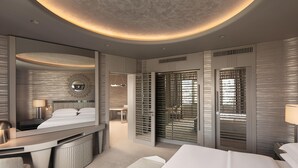 A modern hotel room with a large bed, a desk, a mirror, and a walk-in closet. - Sheraton Ankara Hotel & Convention Center (Ankara)