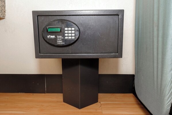 A safe deposit box with a digital keypad and instructions for locking and opening.