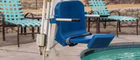 A poolside chair with a blue seat and backrest, positioned next to a pool with a depth marker indicating 3.6 feet.