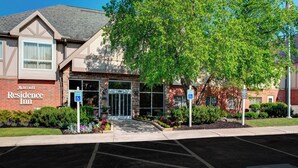 A Marriott Residence Inn with a brick facade, a covered entrance, and a parking lot.