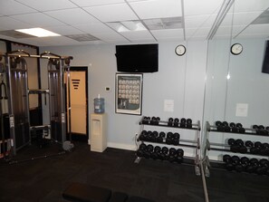 Stay fit on the go with a fully equipped gym featuring cable machines, squat racks, and dumbbells.