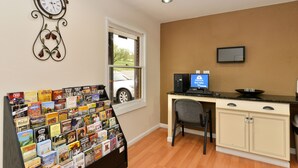 A room with a desk, a computer, a chair, a bookshelf, a clock, and a window. - Americas Best Value Inn Nashville Downtown (Nashville)