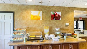 A breakfast bar with various food items and a coffee machine.