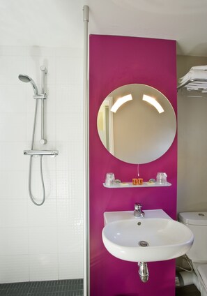 A bathroom with a white sink, a mirror, and a shower. - ibis Styles Lille Centre Gare Beffroi (Lille)