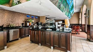 A modern kitchen with a central island, built-in appliances, and a large mural on the ceiling.