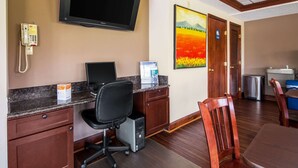 A hotel room with a desk, computer, chair, and a television mounted on the wall. - Econo Lodge Mount Laurel - Philadelphia East (Mount Laurel)