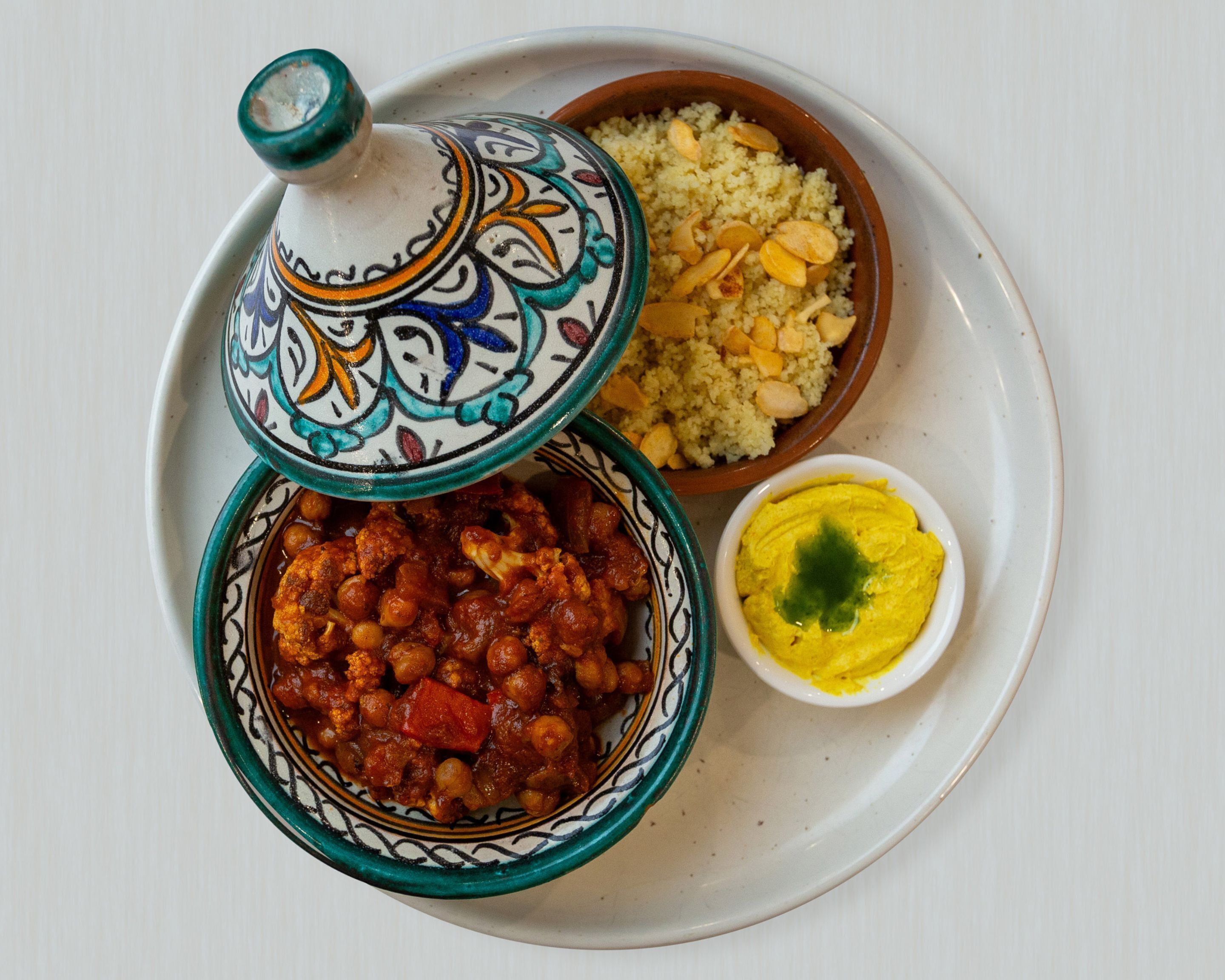 A plate with couscous, chickpeas, and hummus.
