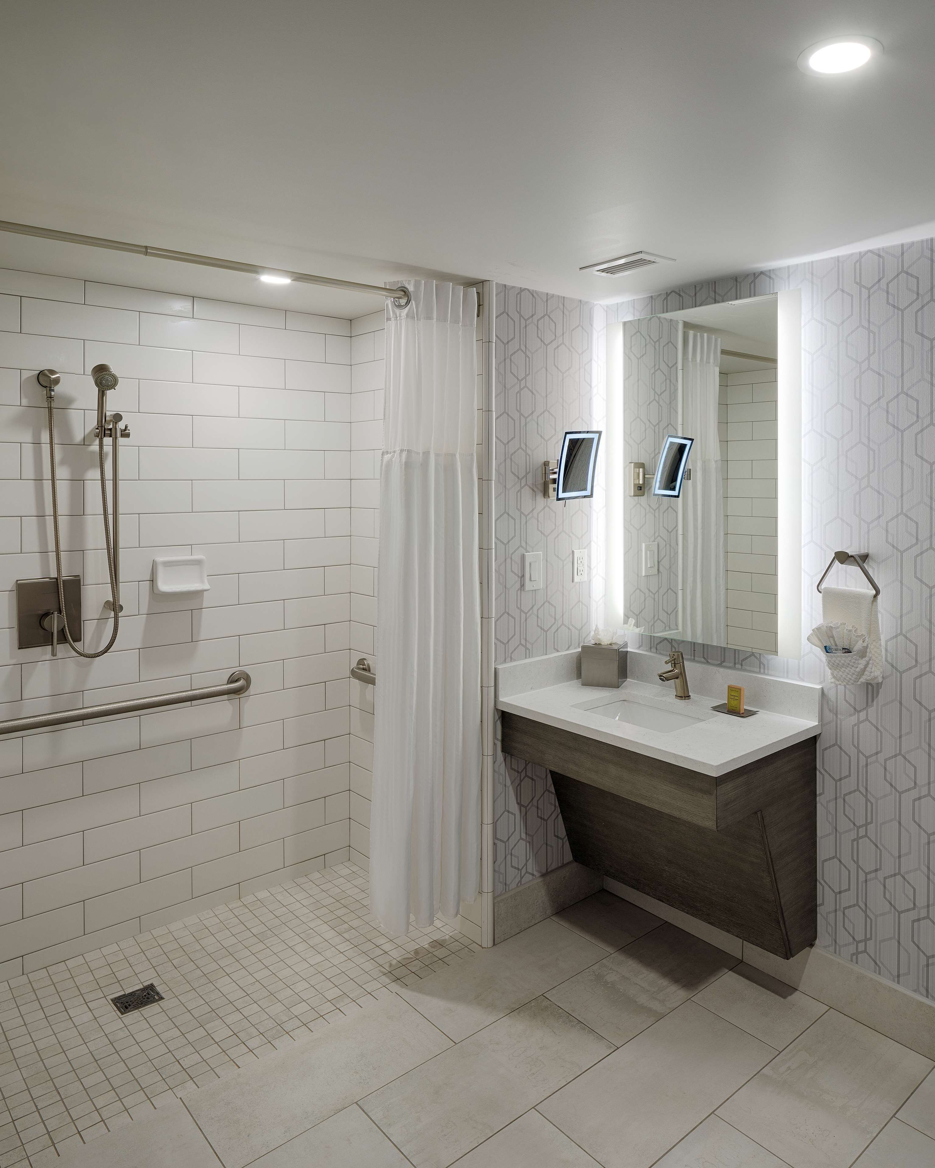 deluxe room, accessible (mobility & hearing, roll-in shower) | bathroom | shower, hydromassage showerhead, designer toiletries, towels