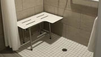 A small, enclosed shower area with a white bench, tiled walls, and a showerhead.