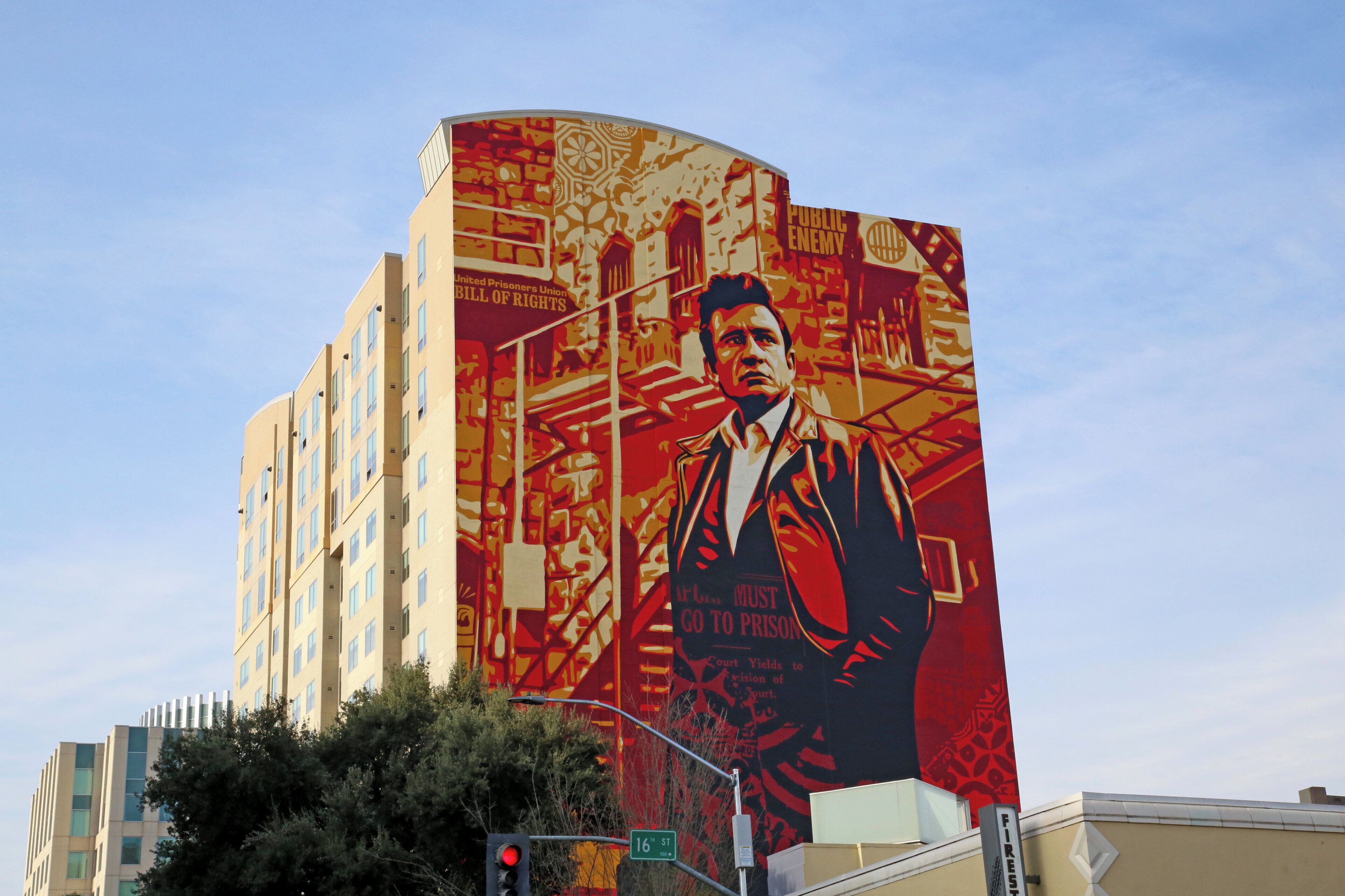 A large mural on a building featuring a man in a suit.