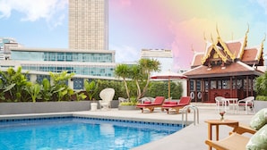 A rooftop pool with lounge chairs, a traditional Thai pavilion, and a modern building in the background. - Montien Hotel Surawong Bangkok (Bangkok)
