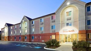 A hotel with a modern facade, multiple balconies, and a clearly marked entrance for 'Sonesta Simply Suites'.