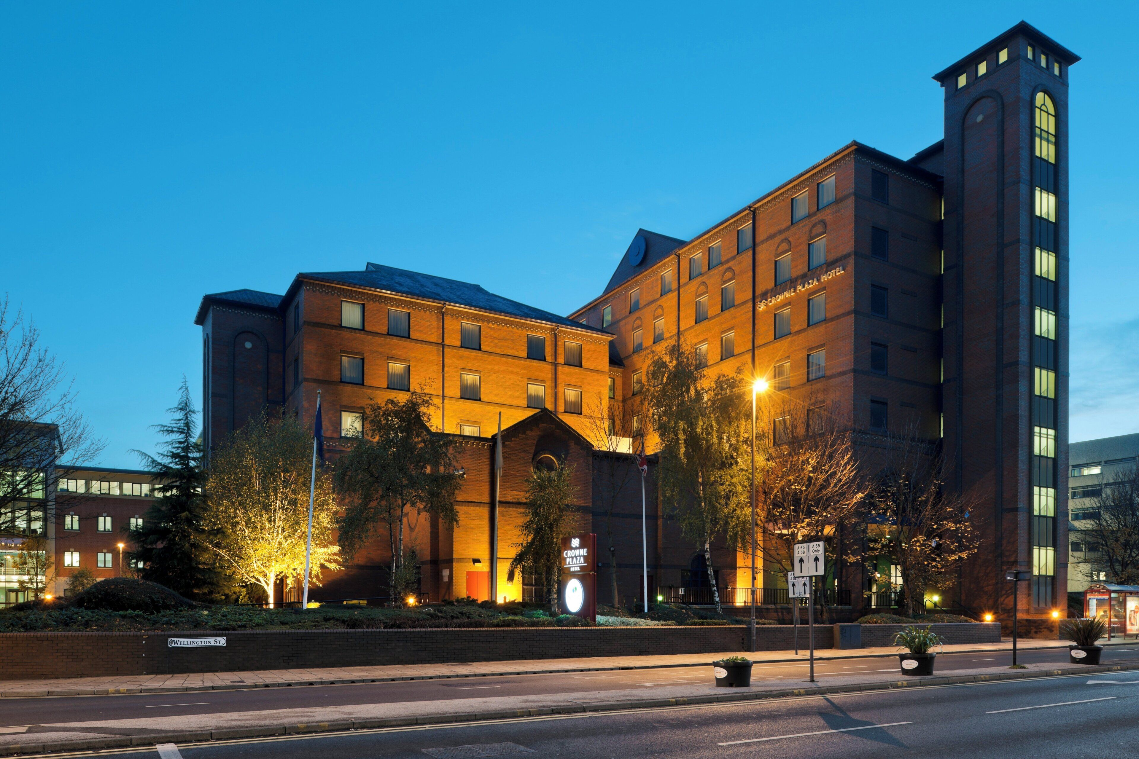 A large hotel with a prominent entrance, multiple floors, and a tall tower.