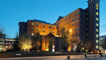 A large hotel with a prominent entrance, multiple floors, and a tall tower.