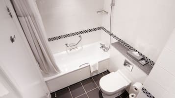 A bathroom with a bathtub, toilet, and shower.