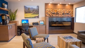 A modern living room with a fireplace, wooden coffee table, and comfortable seating.
