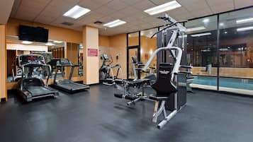 A gym with treadmills, elliptical machines, and weightlifting equipment.