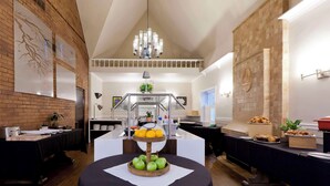 A dining area with a buffet setup, including a fruit display and various food items. - Elm Hurst Inn & Spa, WorldHotels Crafted (Ingersoll)