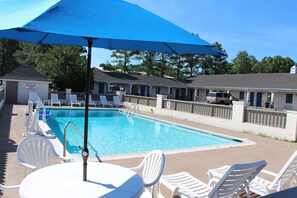 Seasonal outdoor pool, open 10:00 AM to 7:00 PM, pool umbrellas