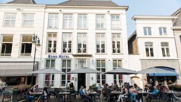 Een hotel met terras en een bordje met de tekst 'Euro Hotel'.