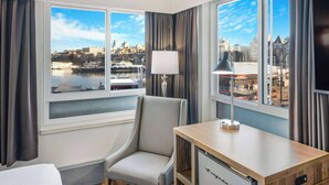 A hotel room with a city view, a desk, a chair, and a TV. - Days Inn by Wyndham Victoria On The Harbour (Victoria)
