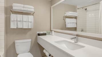 A modern bathroom with a toilet, sink, and towel rack.