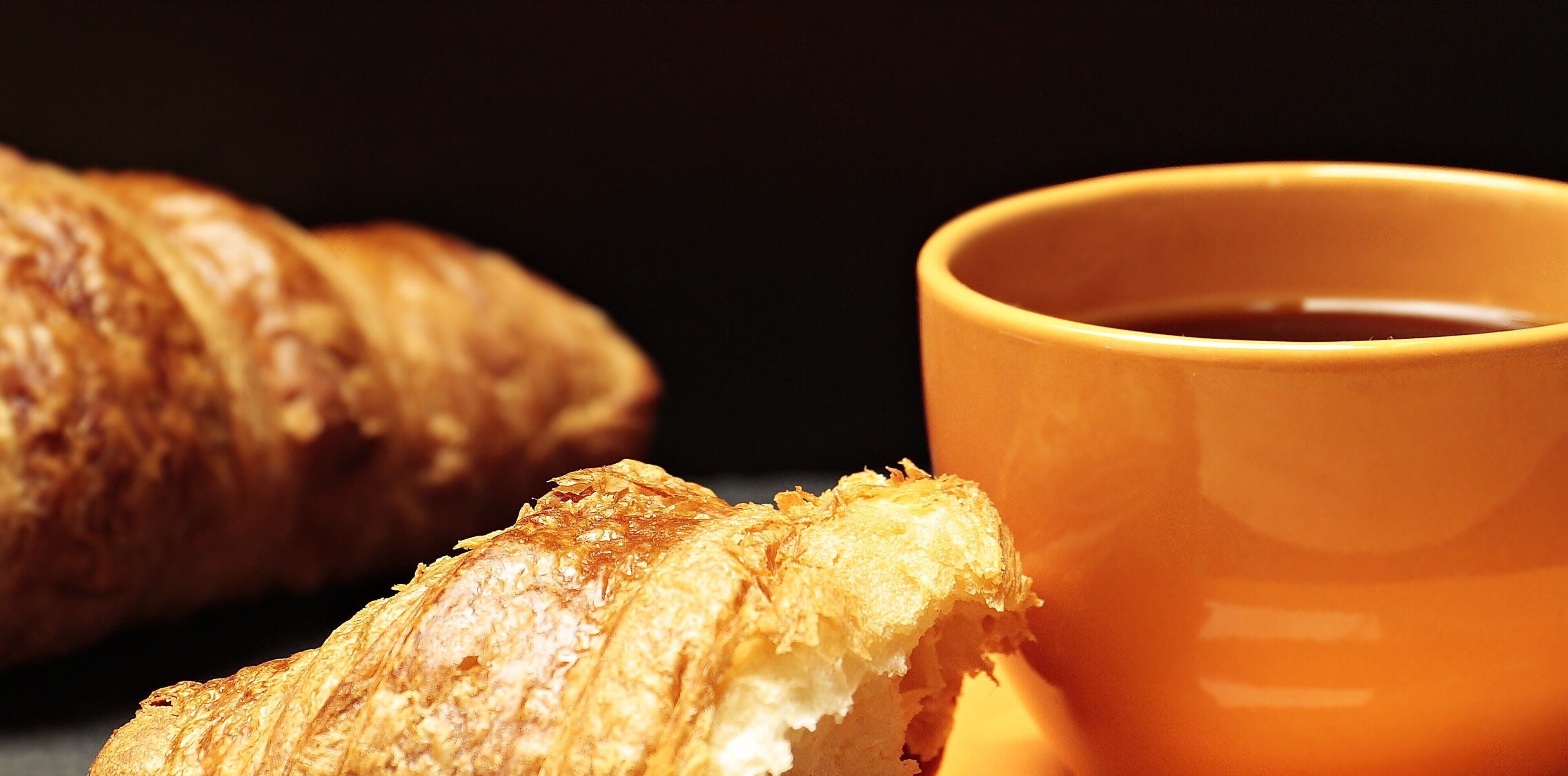 A croissant and a cup of coffee.
