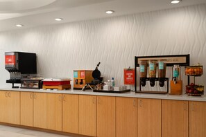 A breakfast bar with a waffle maker, juice dispenser, and various food containers. - Hampton Inn by Hilton Hopewell Fort Lee (Hopewell)