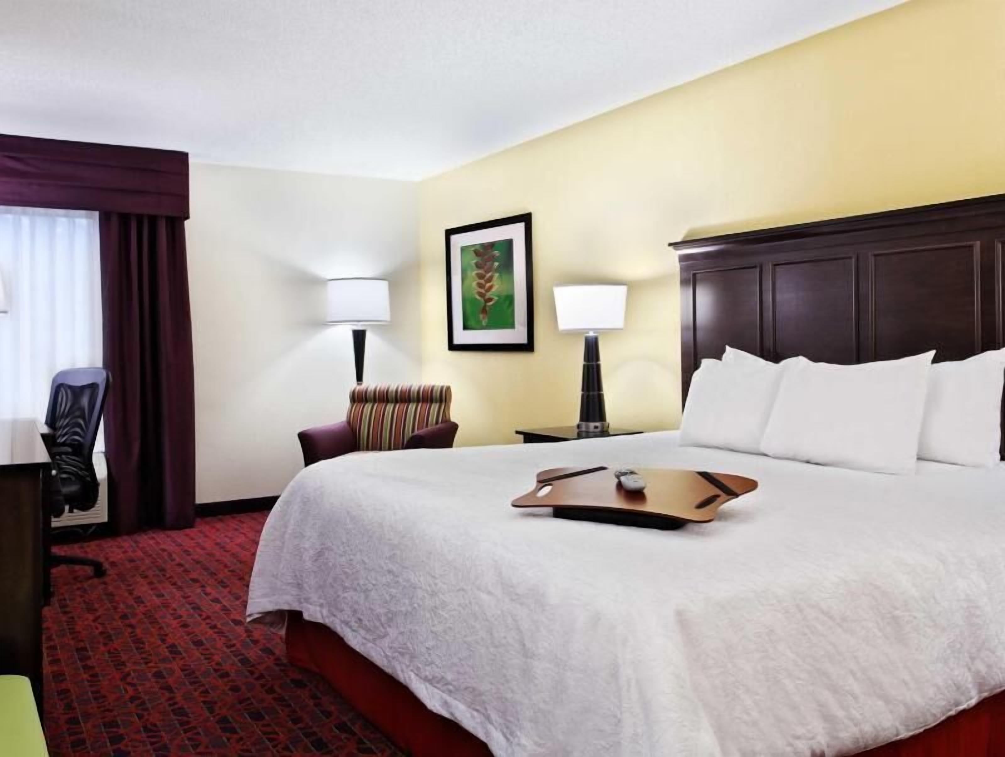 Premium bedding, desk, laptop workspace, blackout curtains