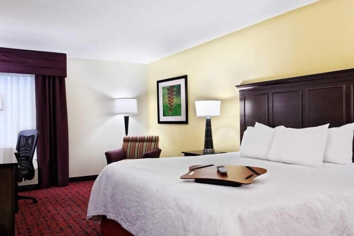 Premium bedding, desk, laptop workspace, blackout drapes