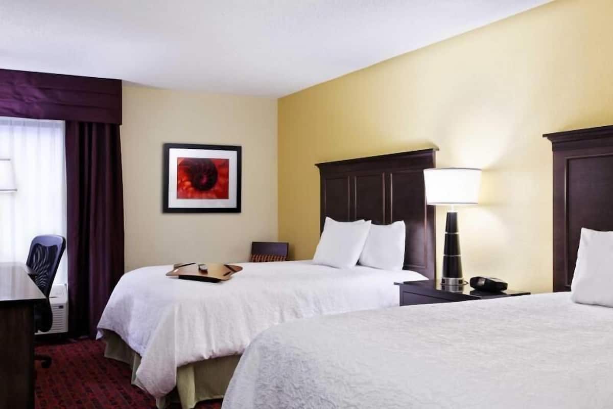 Premium bedding, desk, laptop workspace, blackout drapes