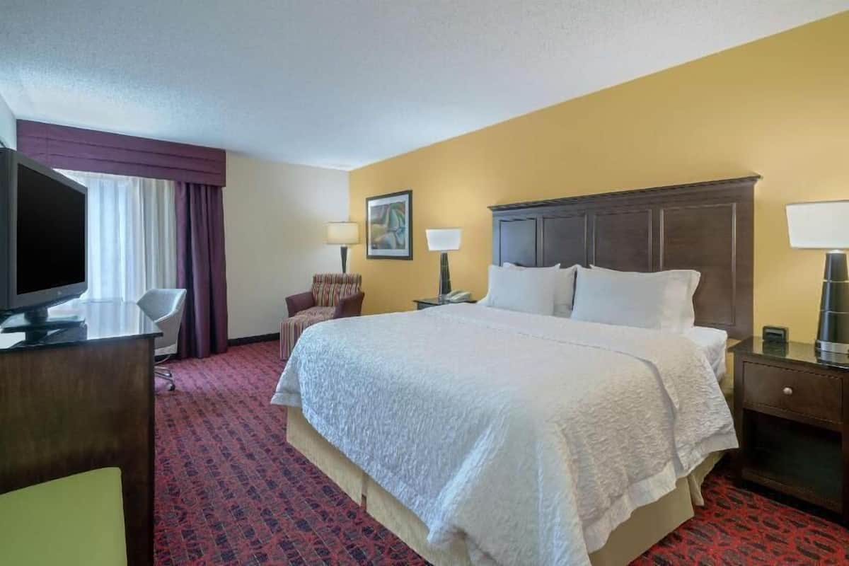 Premium bedding, desk, laptop workspace, blackout drapes
