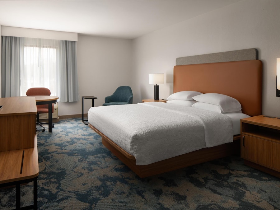 Premium bedding, desk, laptop workspace, blackout drapes