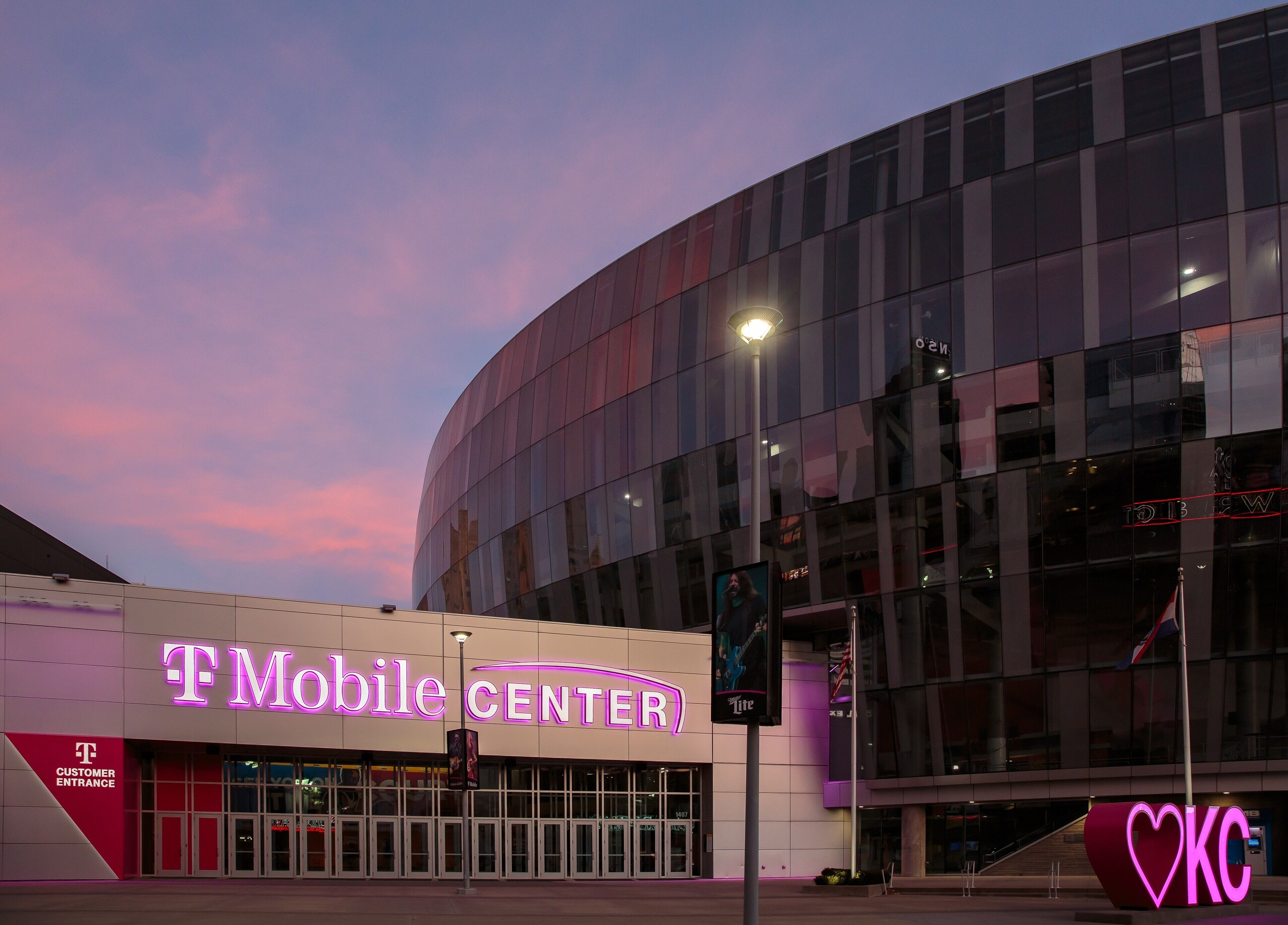 A modern building with a large glass facade and a prominent 'T-Mobile Center' sign.