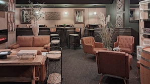 A modern interior with leather sofas, wooden tables, and decorative plants.