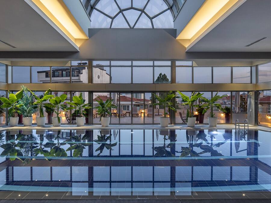 Indoor pool, pool umbrellas, pool loungers