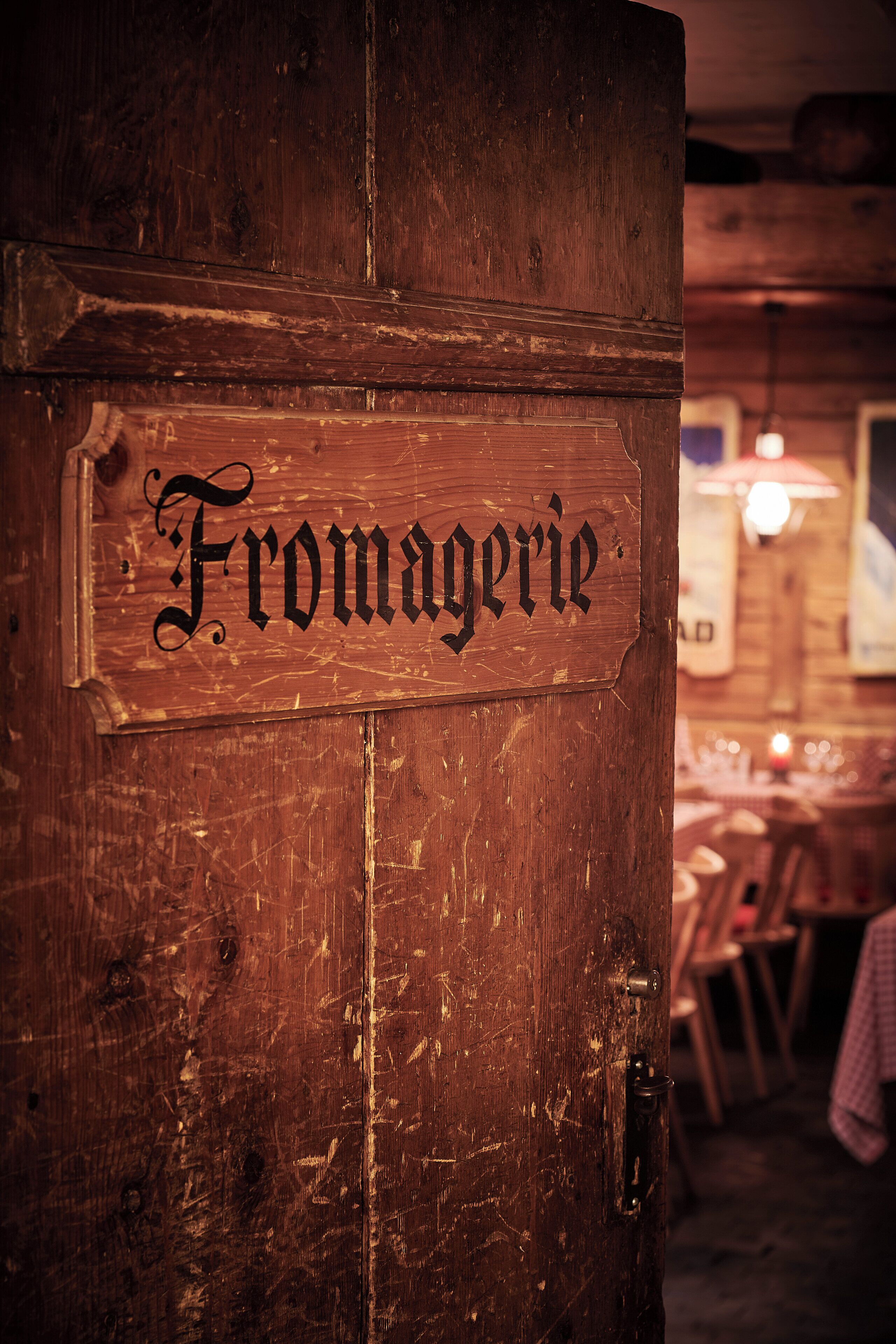 A wooden door with a sign that reads "Fromagerie."