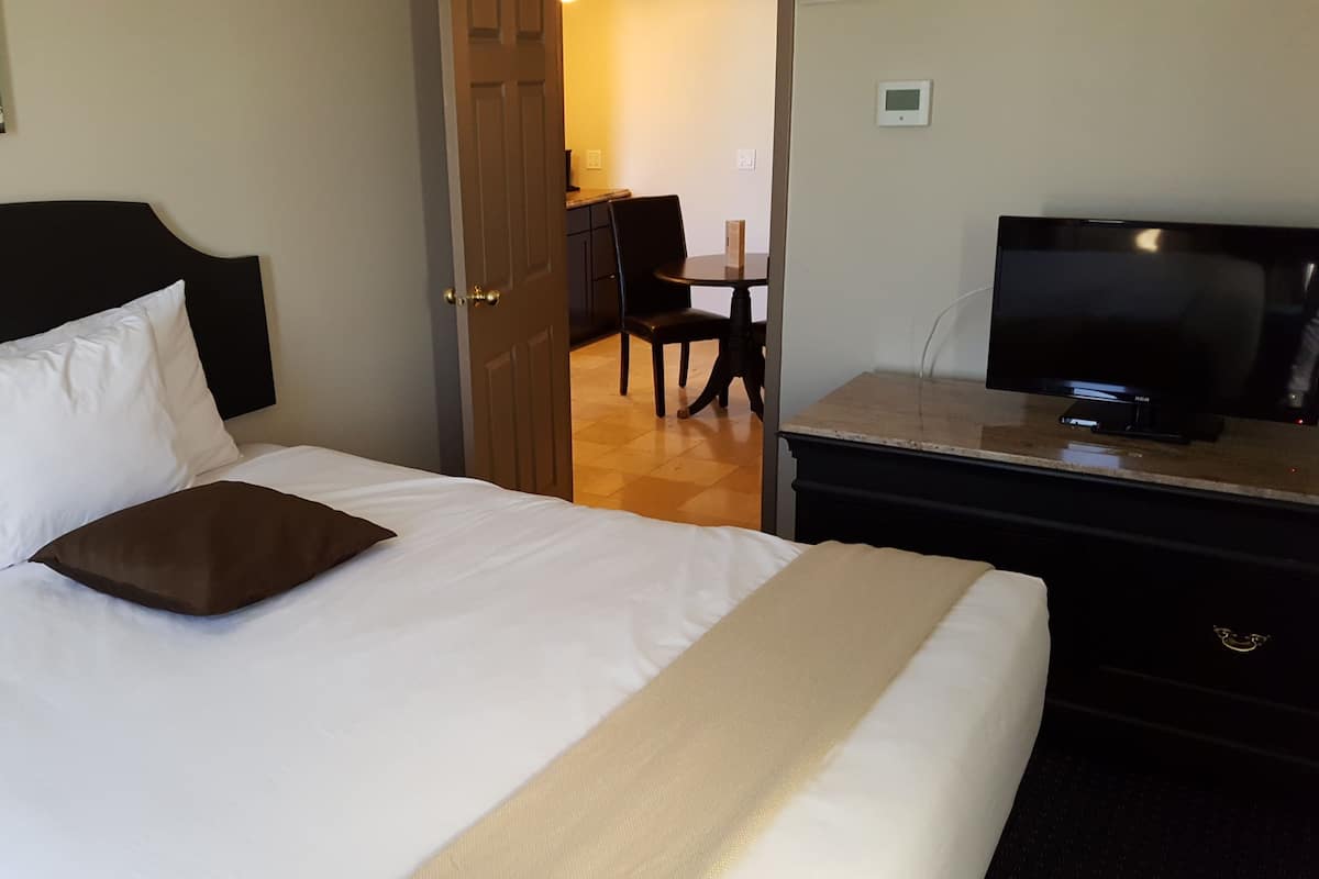 Two Bedroom Suite (No pets allowed) | Desk, blackout curtains, iron/ironing board, free cots/infant beds